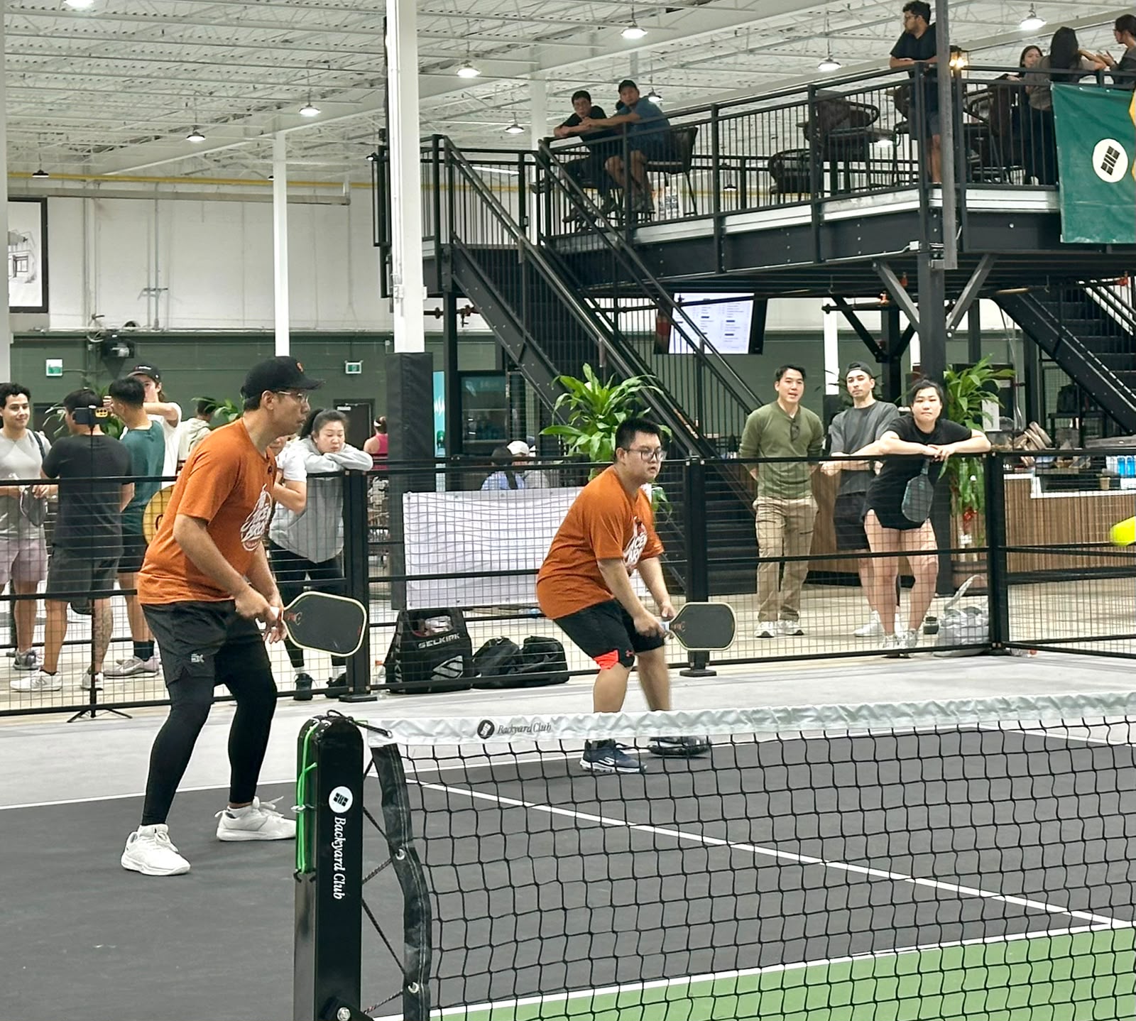 Daven and Adrian at the net, paddles up, ready for the return
