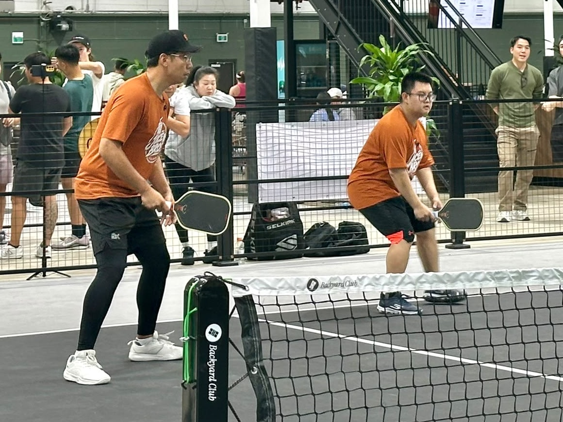 Daven and Adrian at the net, paddles up, ready for the return
