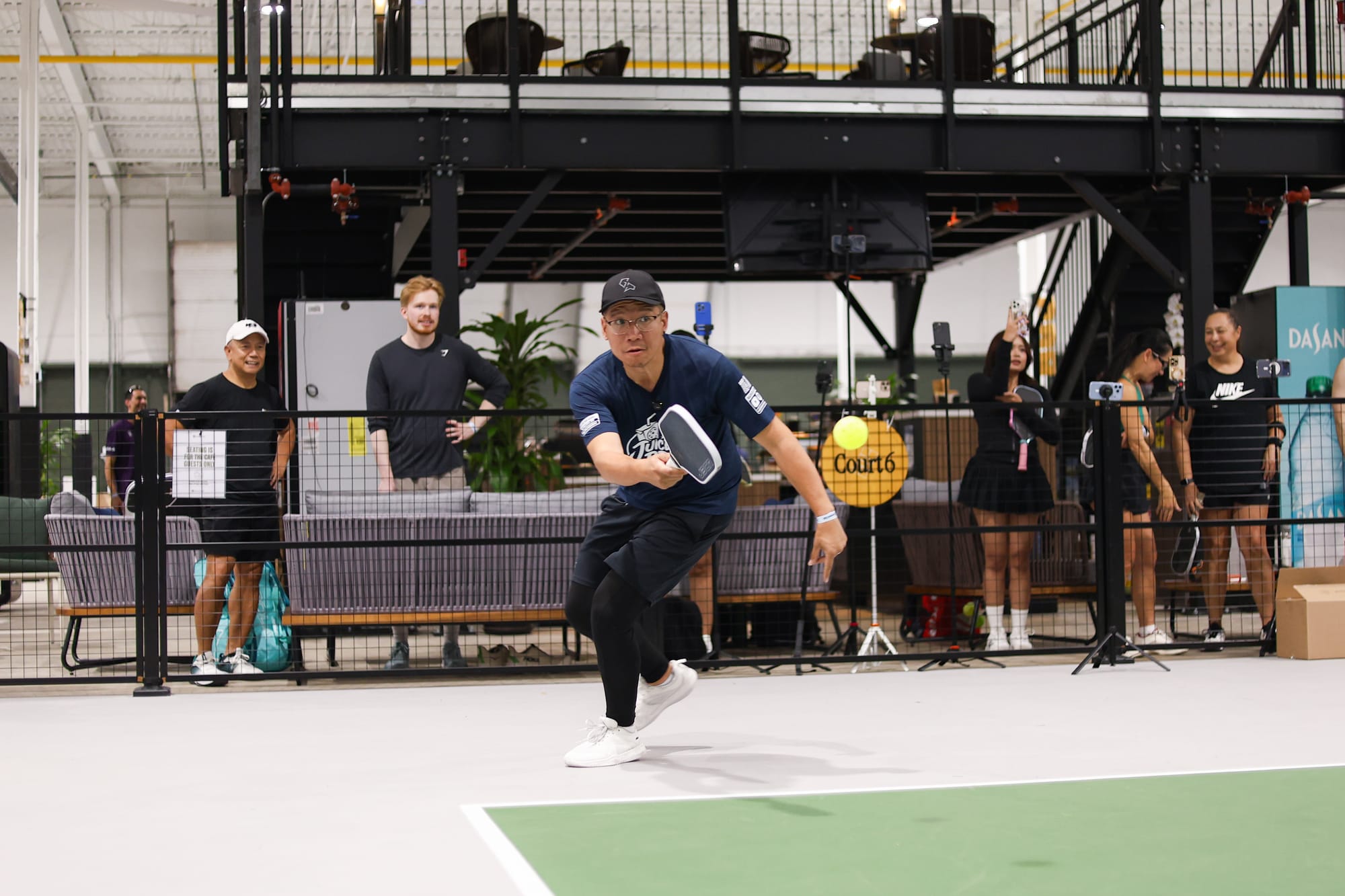 Daven lunging into a forehand with the ball just ahead of his paddle