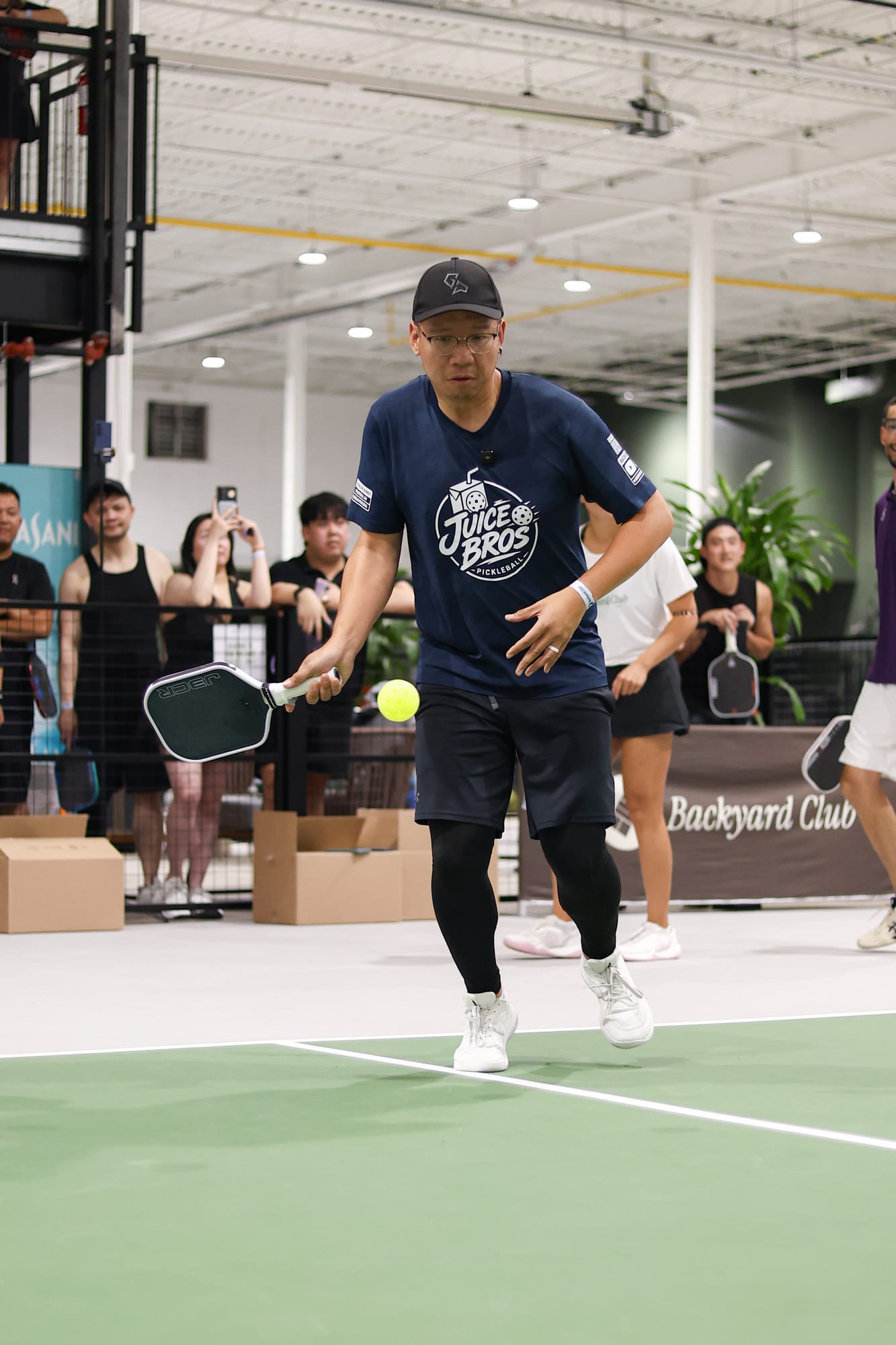 Daven in a cap and Juice Bros shirt, stepping in with his paddle low and ready